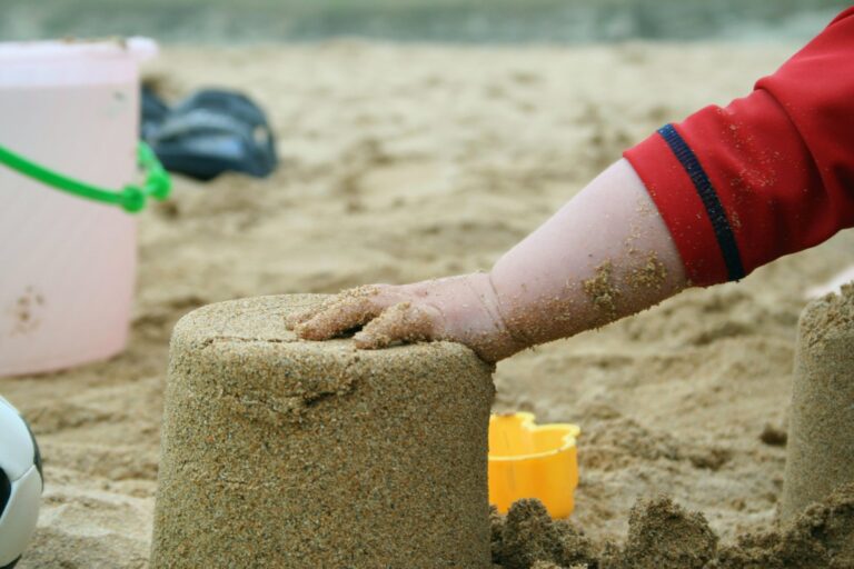 Child building a sandcastle on the beach