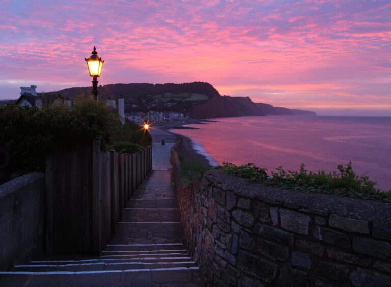Sidmouth seafront under a pink evening sky
